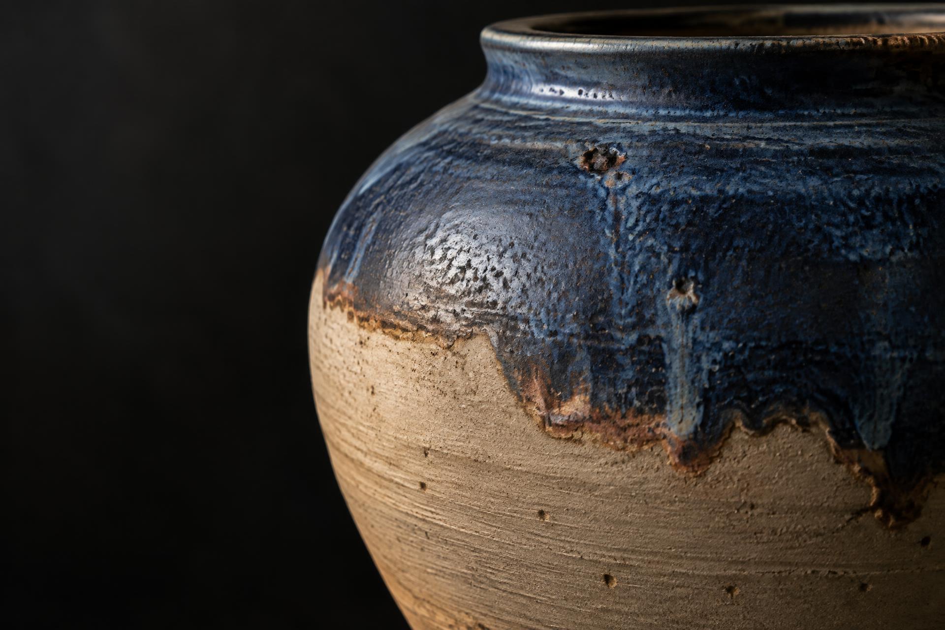 Macro view of a stoneware vessel with deep cobalt glaze