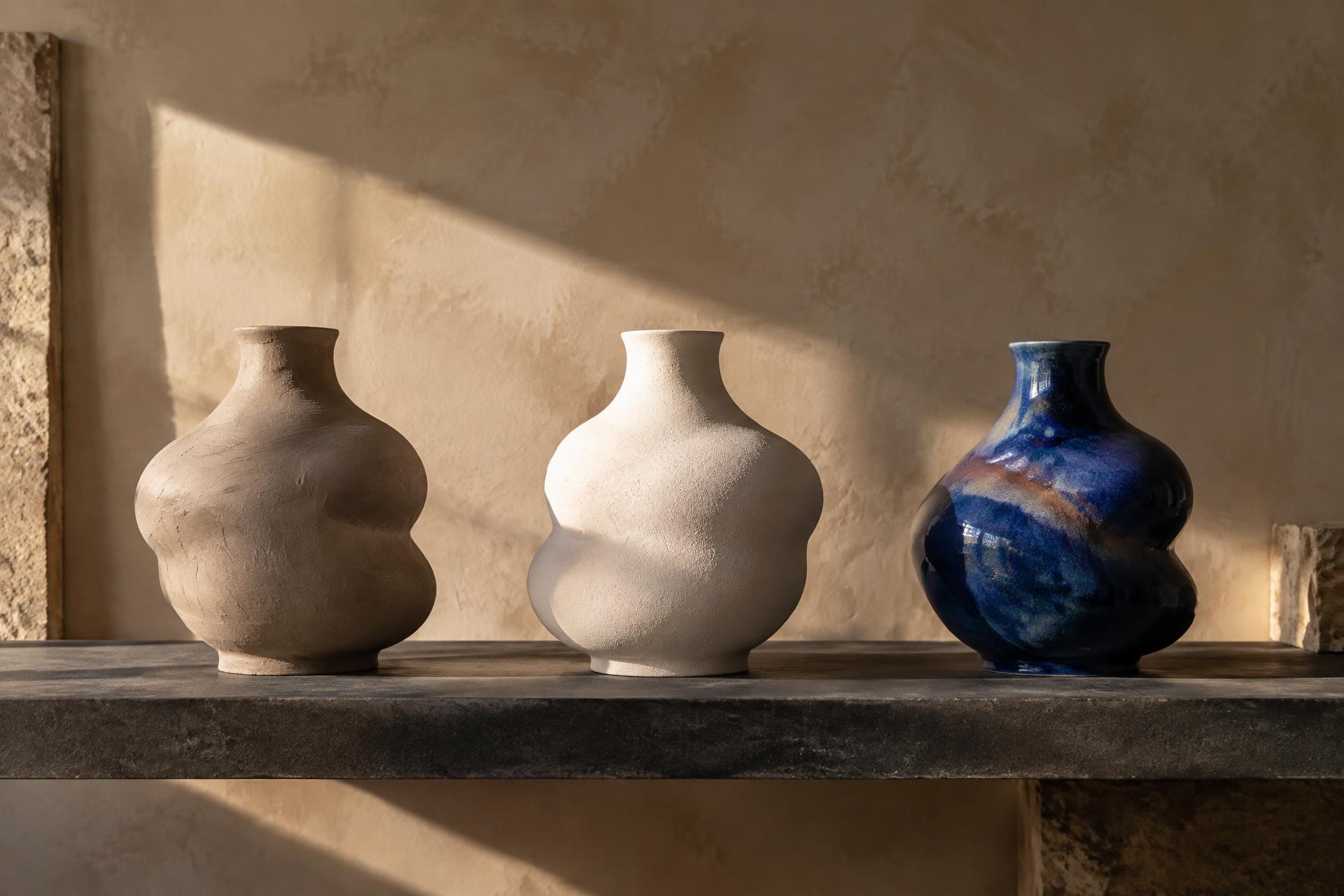 Three related vessels showing raw clay, pale bisque and deep cobalt glaze